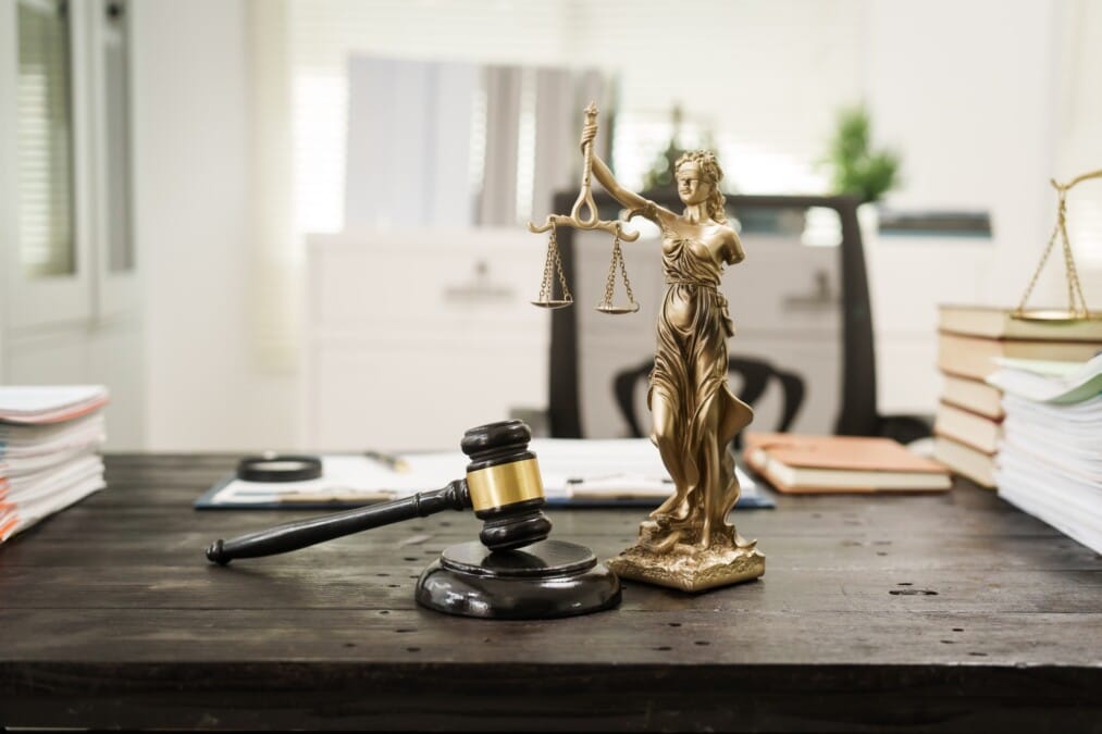 A lawyer's desk in the office is filled with legal documents.The lawyer provides consultations
