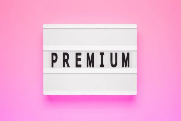 The word premium on lightbox isolated pink background. Premium Membership Concept.